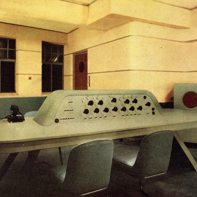 The dramatic control room with yellow walls, and central control panel with chairs, designed by modernist architect Wells Coates of BBC Broadcasting House in London.