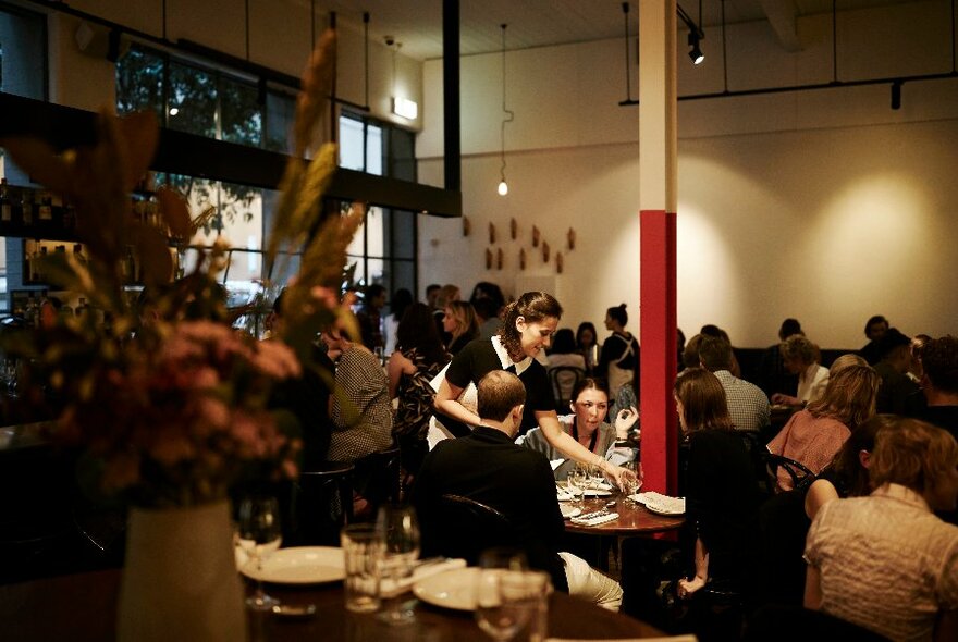 People seated in a busy restaurant.