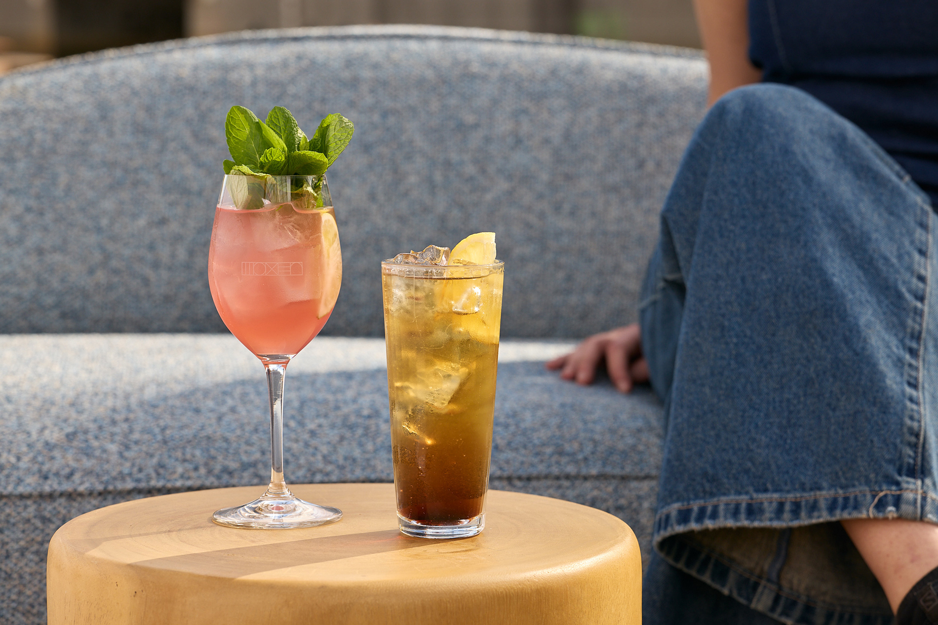 Two fruity cocktails on a table.