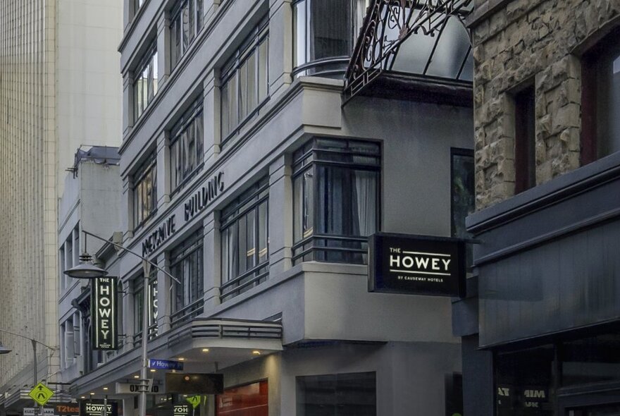 Howey Place entry with hotel signage and surrounding art deco buildings.