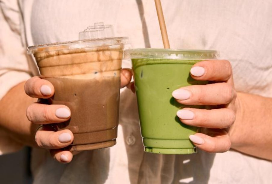 Two drinks being held in seperate hands