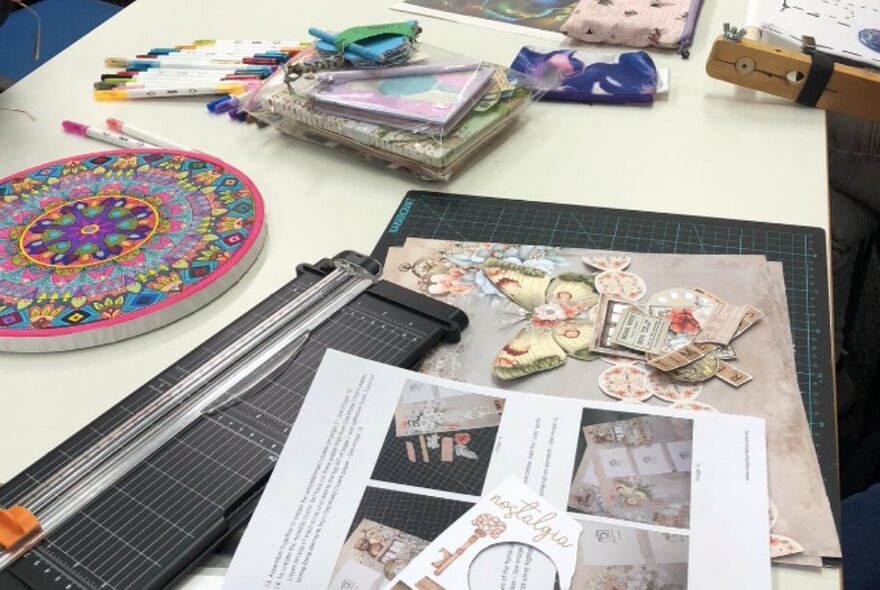 A selection of materials and tools used for paper handcrafting projects.