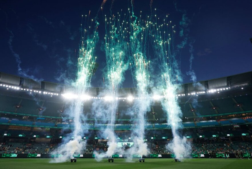 Fireworks going off in the middle of the MCG at night. 