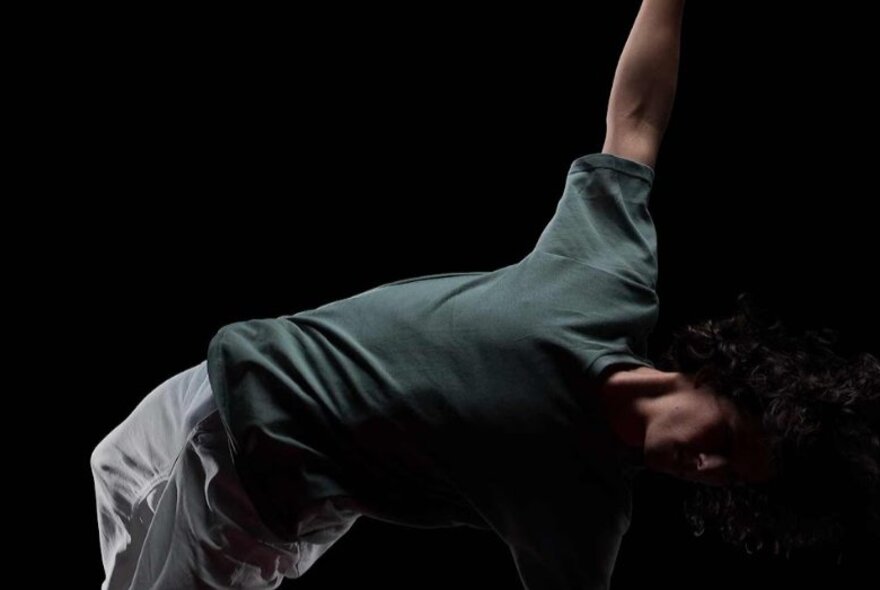 Art photograph of a person falling with legs and arms twisted.