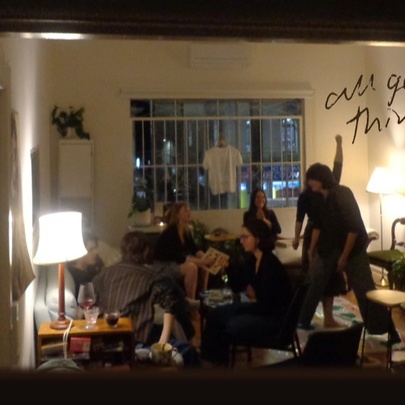 A mirror reflecting a group of people in a room with lamps.