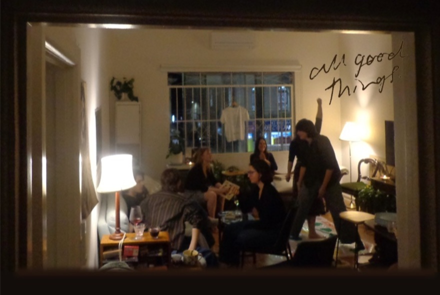 A mirror reflecting a group of people in a room with lamps.