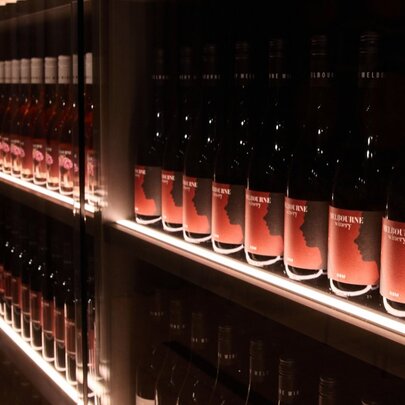 A wall of shelves filled with wine bottles. 