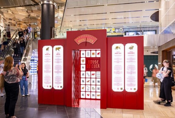 Shoppers standing around the House of Luck interactive installation at Emporium Melbourne, created for the Lunar New Year celebrations. 