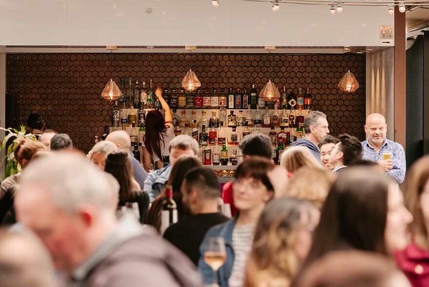 People gathered, socialising and drinking at The Stolen Gem Rooftop Bar.