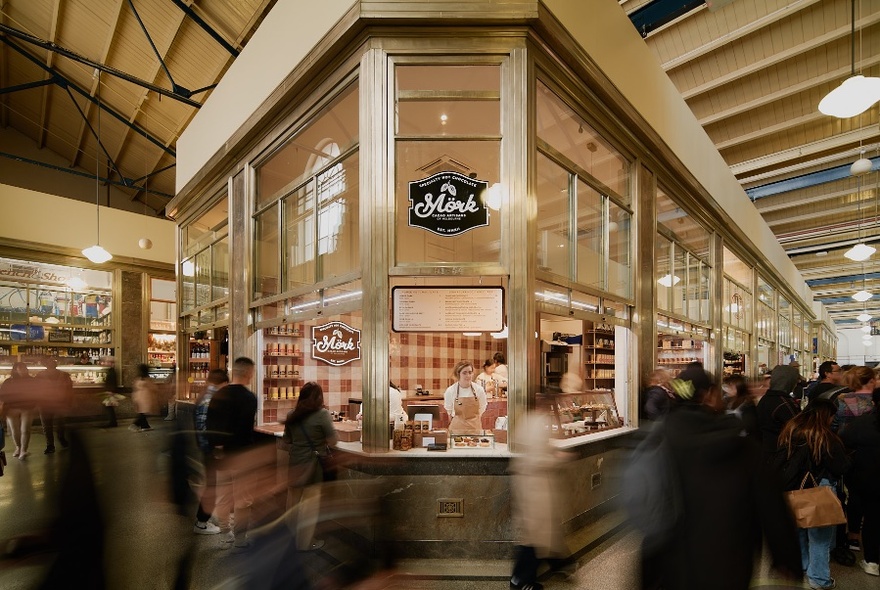 Service counter within large market hall, people blurred around the hallways.