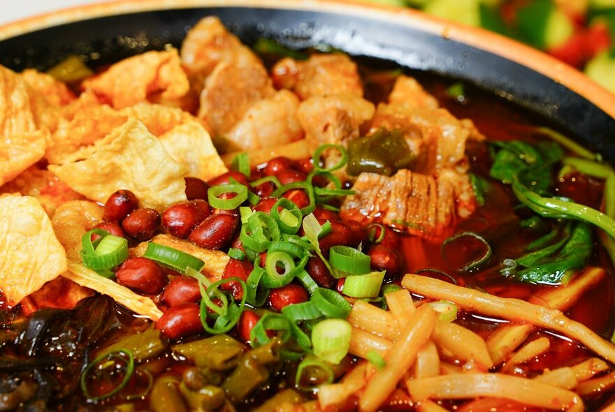 Bowl of noodles, crispy pork and vegetables.