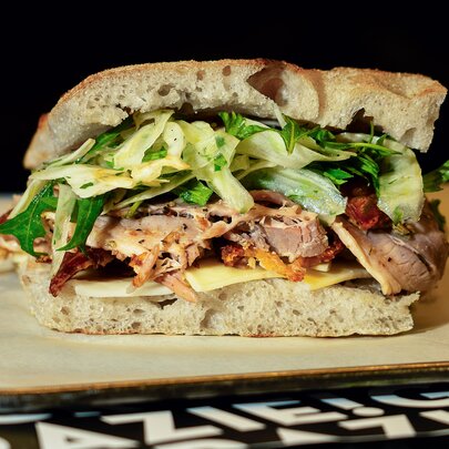 A focaccia sandwich with pork and fennel.