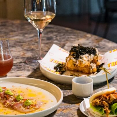Dishes of food and drinks on a restaurant table.