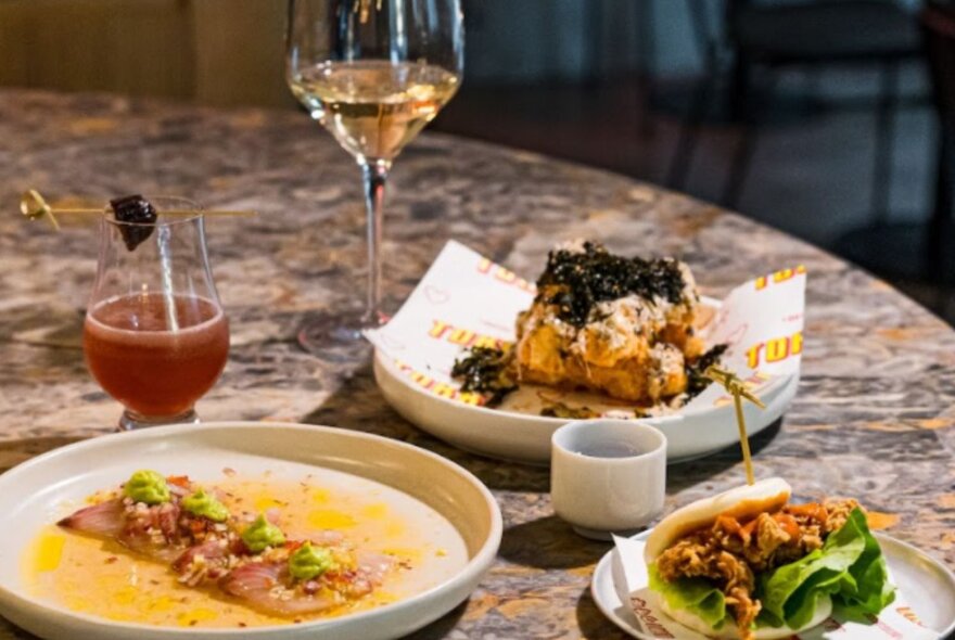 Dishes of food and drinks on a restaurant table.