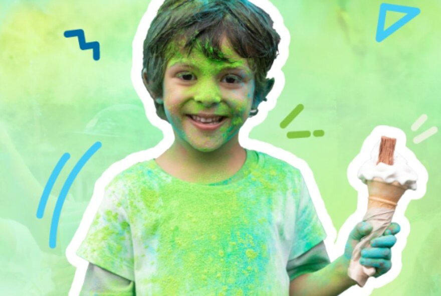 A child holding an ice cream, with green powder on his face and T-shirt.