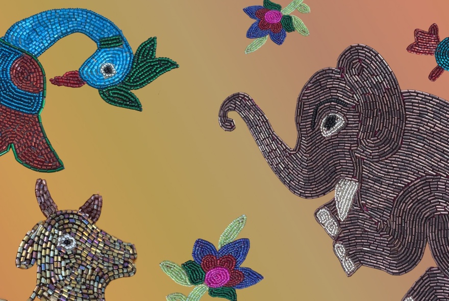 Embroidered bead artwork with elephant flowers, bird and beast.