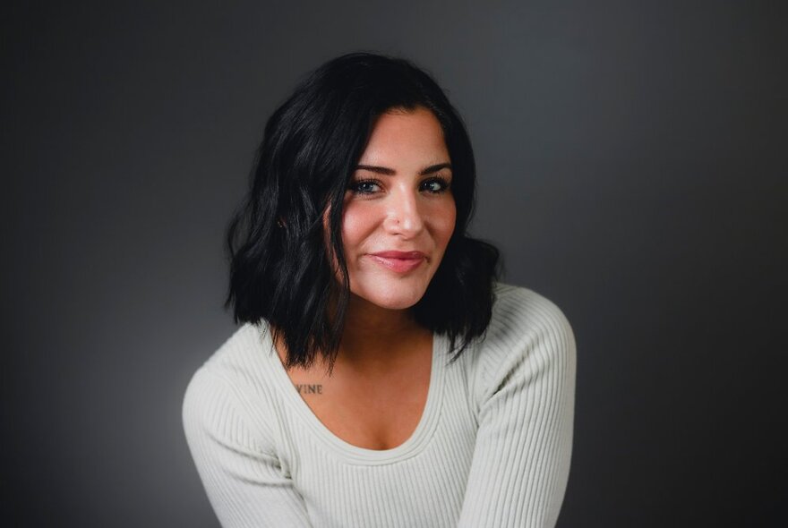 Author Lauren Roberts leaning forward slightly and smiling. 