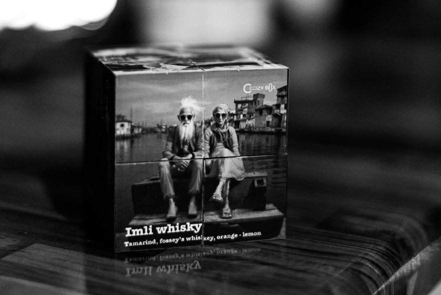Box with an image of two old Indian men advertising whisky.
