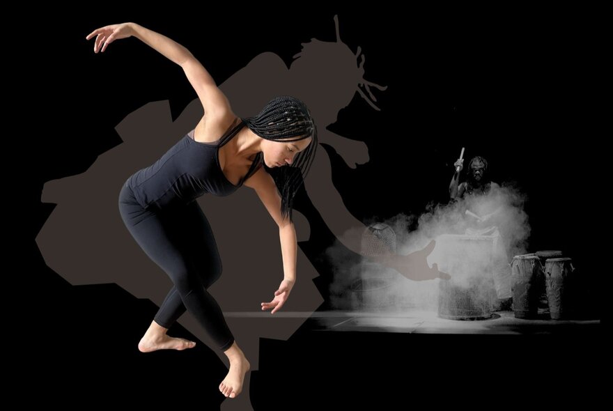Dancer wearing black leotard performing with arms curved.