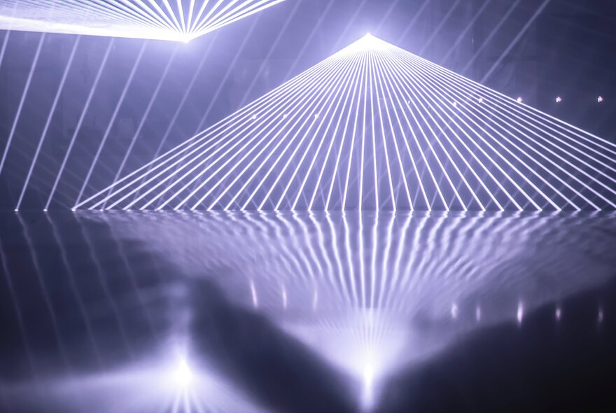 Light beams form geometric planes and vast three-dimensional environments.
