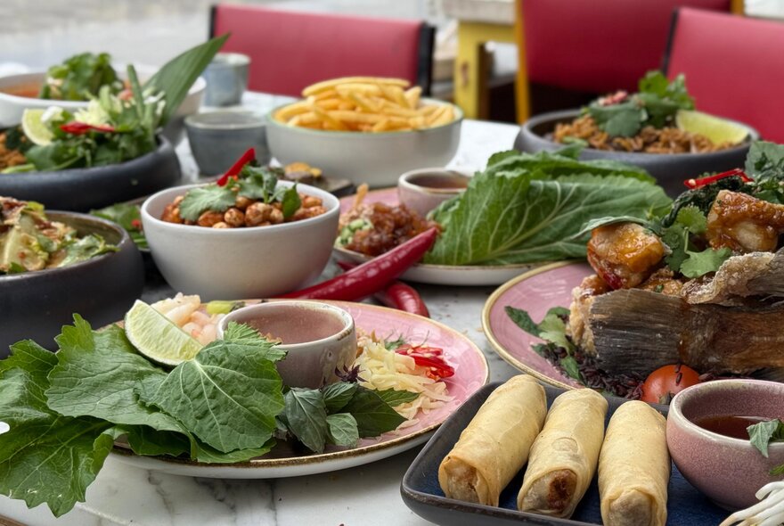 Looking across a table at a Thai feast.