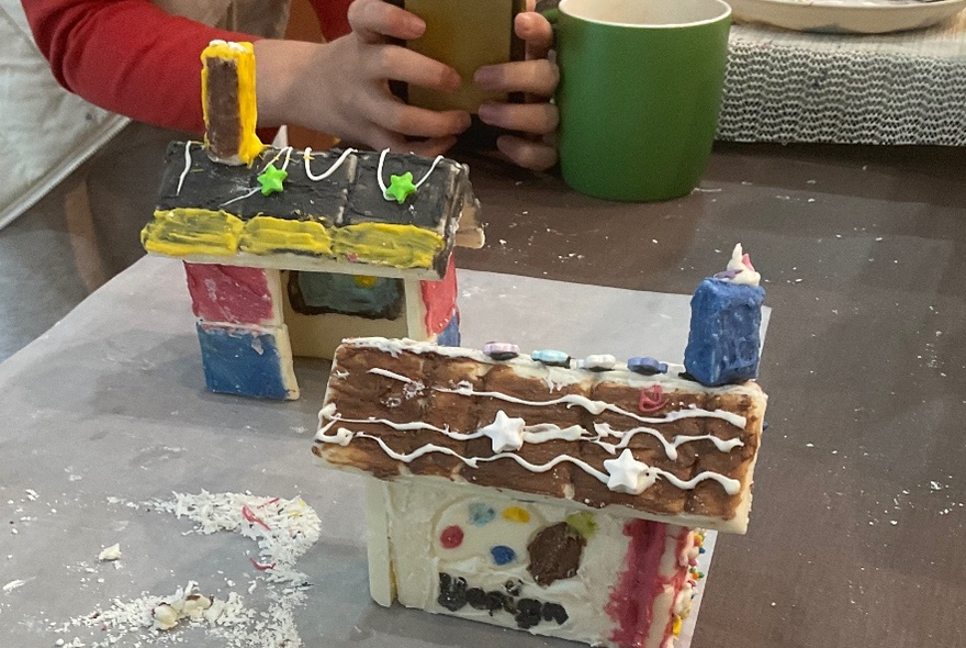 Edible house made of gingerbread with icing details.