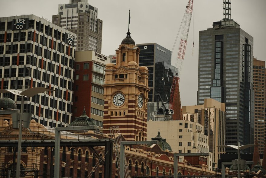 City rooflines including Flinders St Station and skyscrapers.