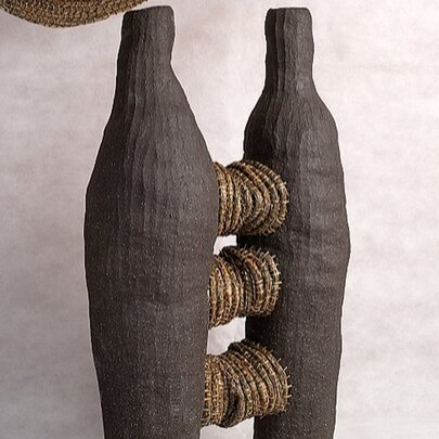 Sculpture with black skittles and rope.