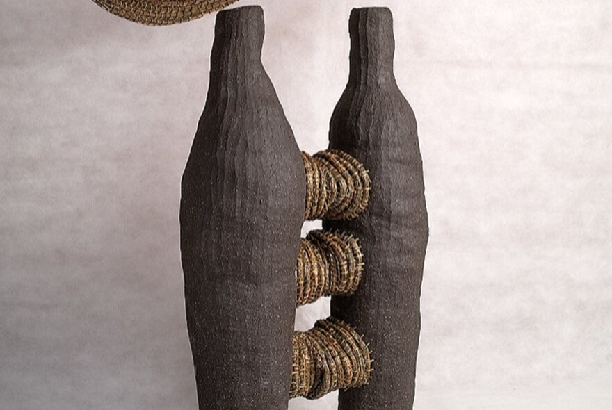 Sculpture with black skittles and rope.