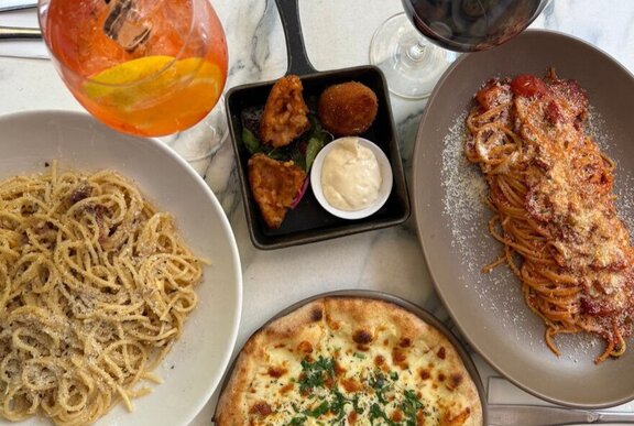 An array of Italian dishes including pasta and pizza.