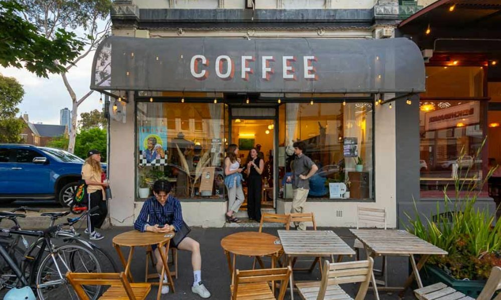 The exterior of a cafe at dusk