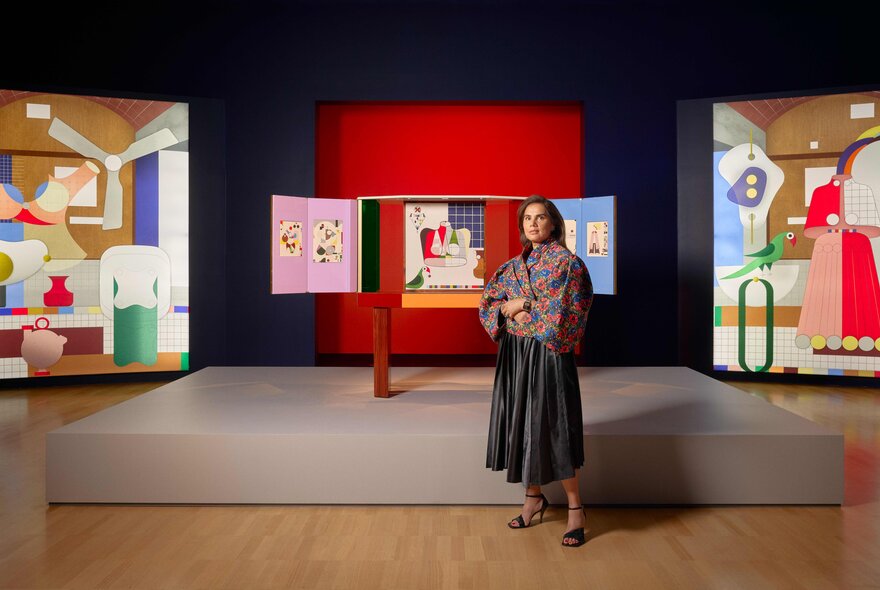 Designer Nipa Doshi standing in front of her installation of designed pieces at the National Gallery of Victoria.