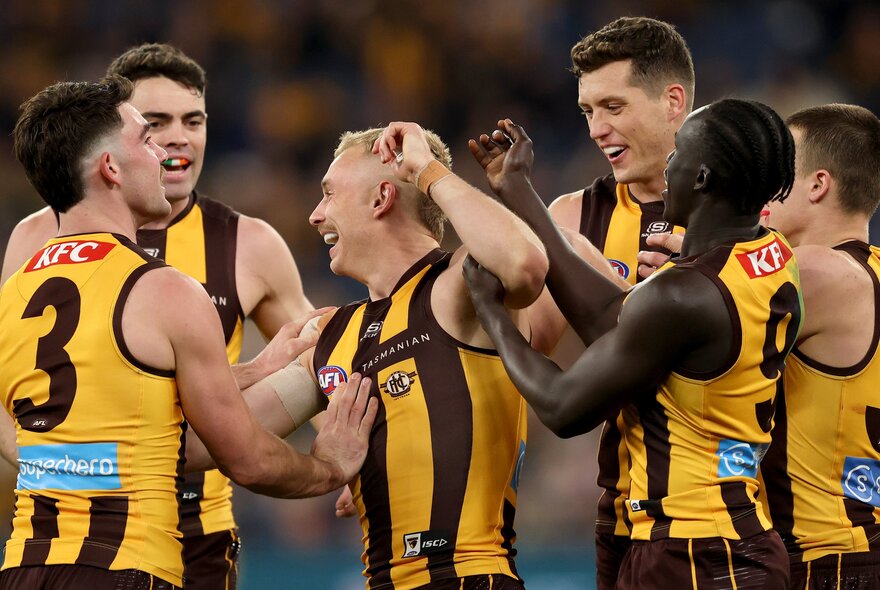 Hawthorn football players happy and celebrating. 