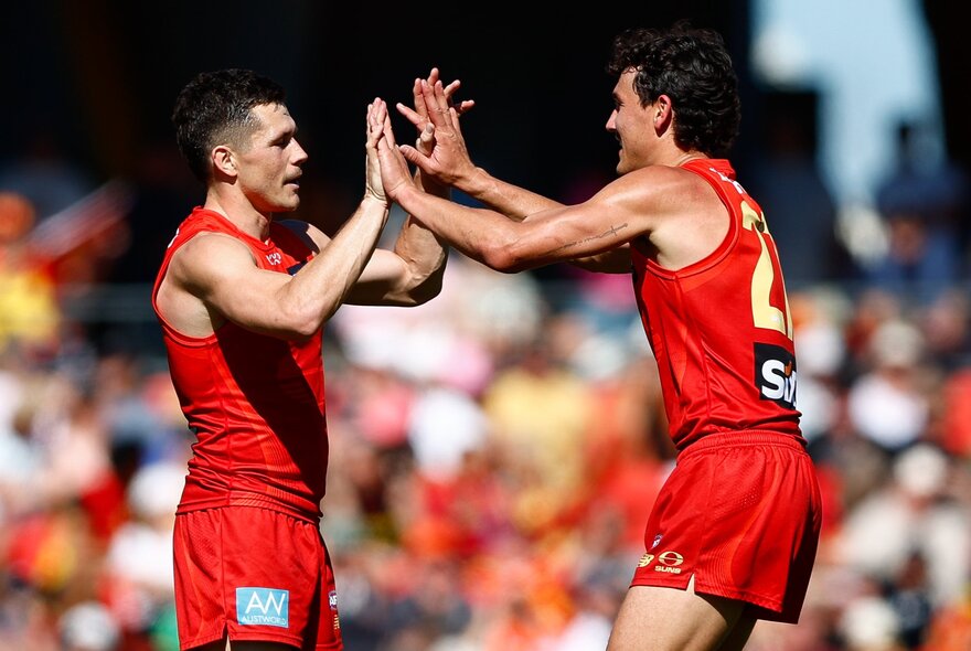 Gold Coast AFL football players on the field during a match.

