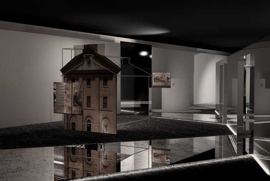 An exhibition room with mirrors on the floor and a model house.