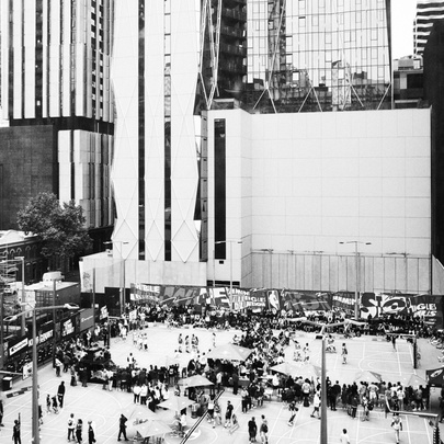 Crowds gathered around basketball courts dwarfed by surrounding city buildings.