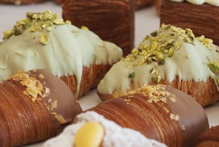 Iced pastries topped with chopped nuts.