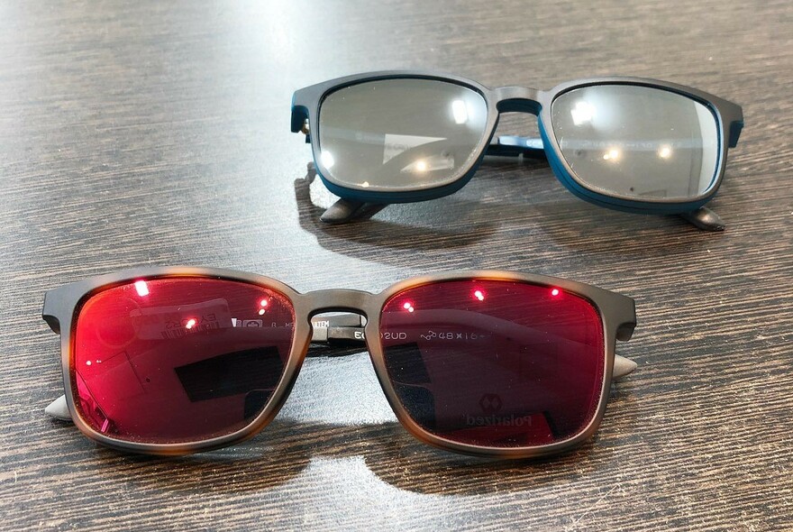 Two pairs of glasses, one with red lenses.