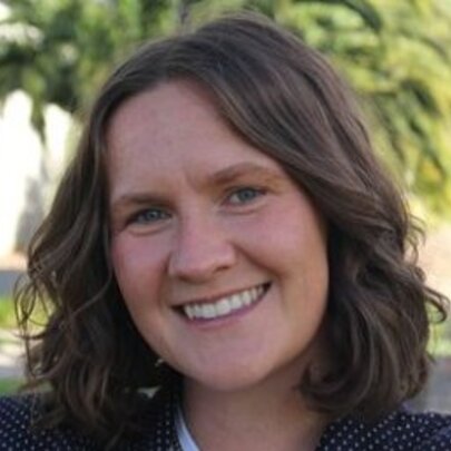 Author Jessica Irwin, smiling with shoulder-length brown hair.