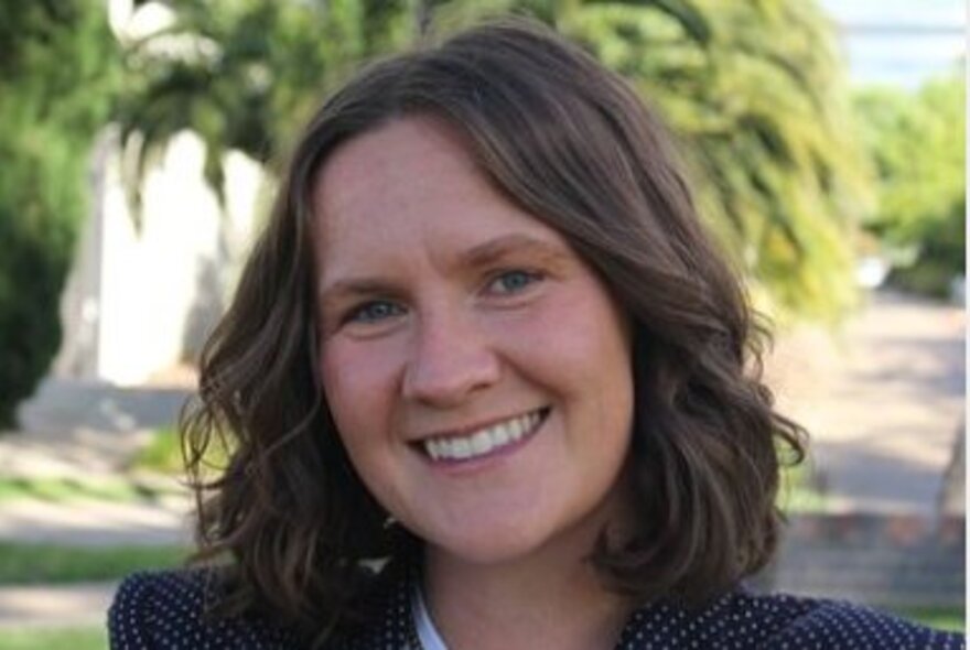 Author Jessica Irwin, smiling with shoulder-length brown hair.
