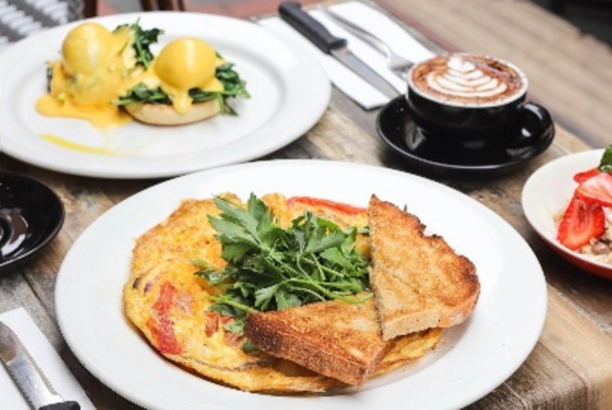 Eggs Benedict, toast and pancake, with coffee.