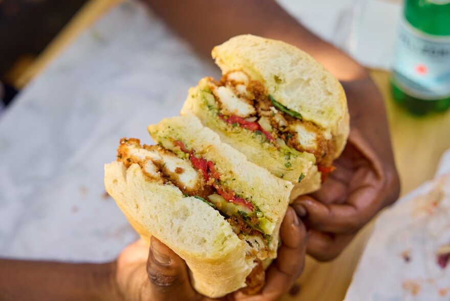 A cross-section of a panini containing cottoletta sliced in half