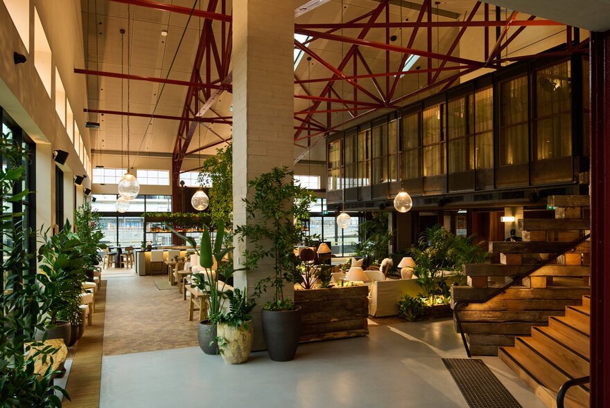 Hotel foyer with lounge seating and pendant lighting.