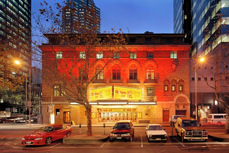 Comedy Theatre building on Exhibition Street at night.