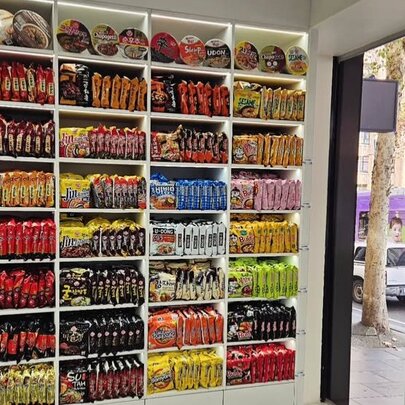 Shelves packed with colour-coded packages in a Korean supermarket.
