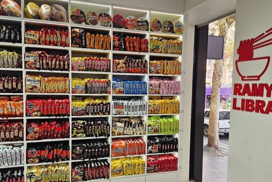 Shelves packed with colour-coded packages in a Korean supermarket.