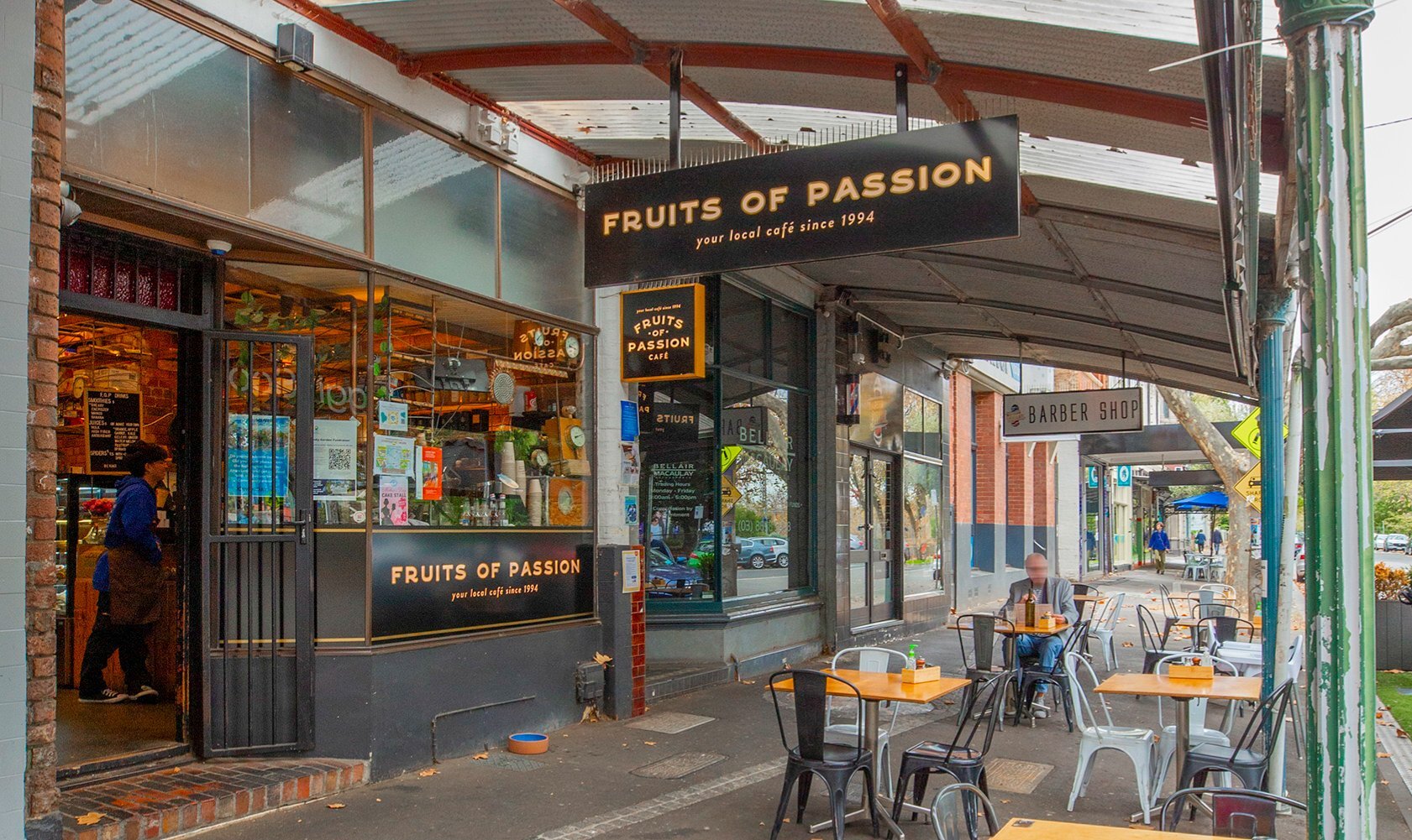 A man sitting outside a cafe. 
