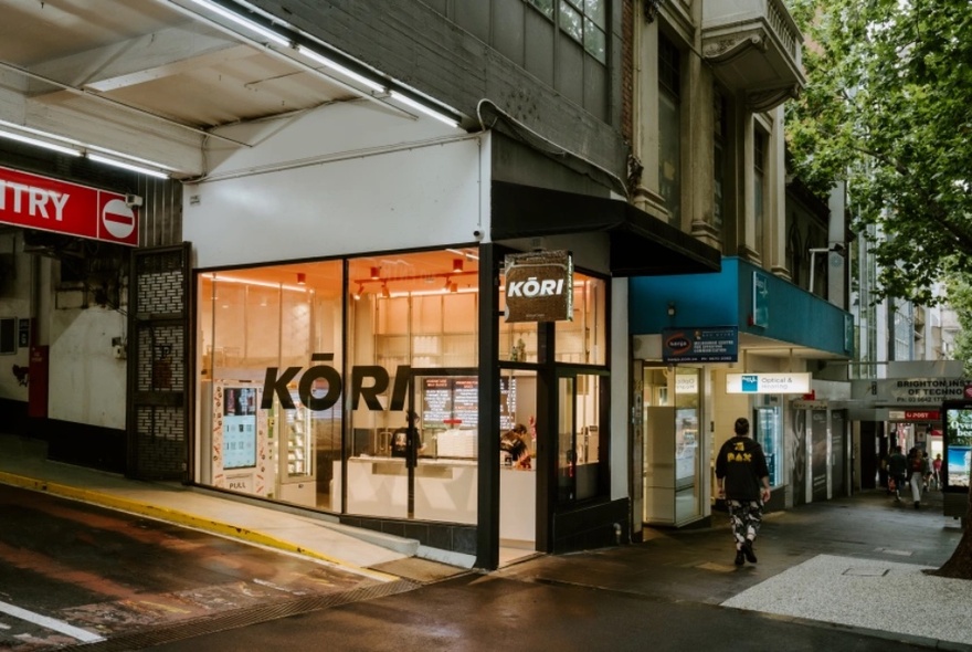 The exterior of Kori Ice Cream shop with a person walking past. 