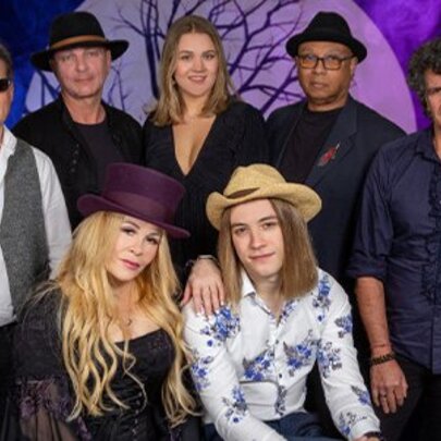 A band of singers and musicians in a group photo.