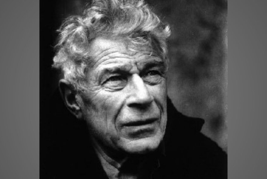 A black and white portrait of John Berger, an older male with wisened face.